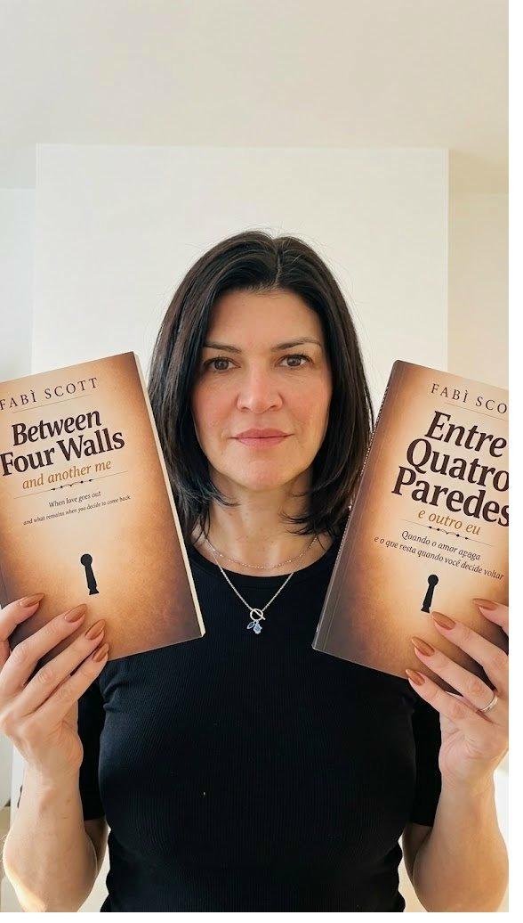 Fabì Scott holding both editions of the book